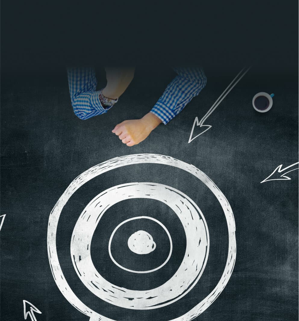 Target drawn in chalk on a blackboard, with several arrows pointing at it