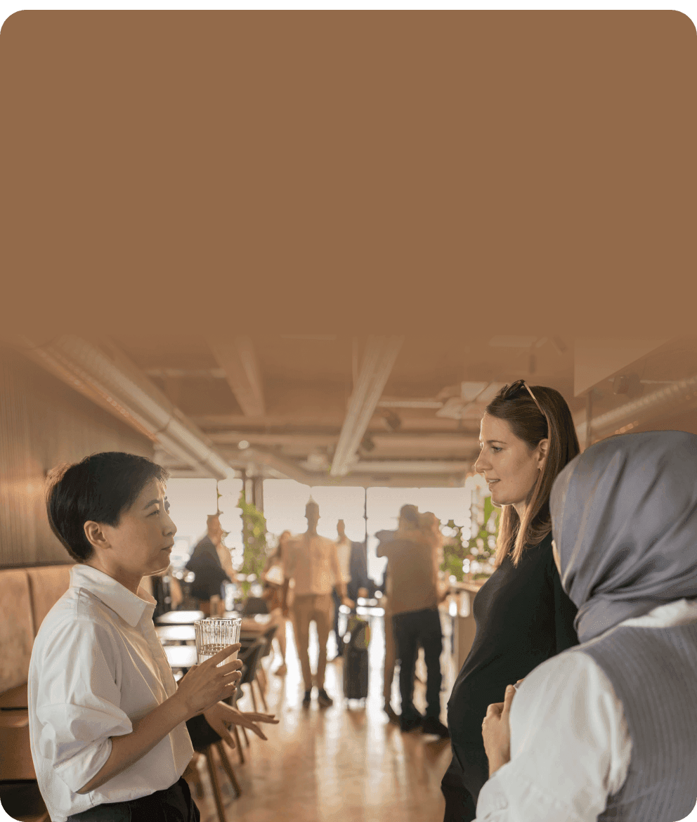 Employees talking at a get-together in a bright office