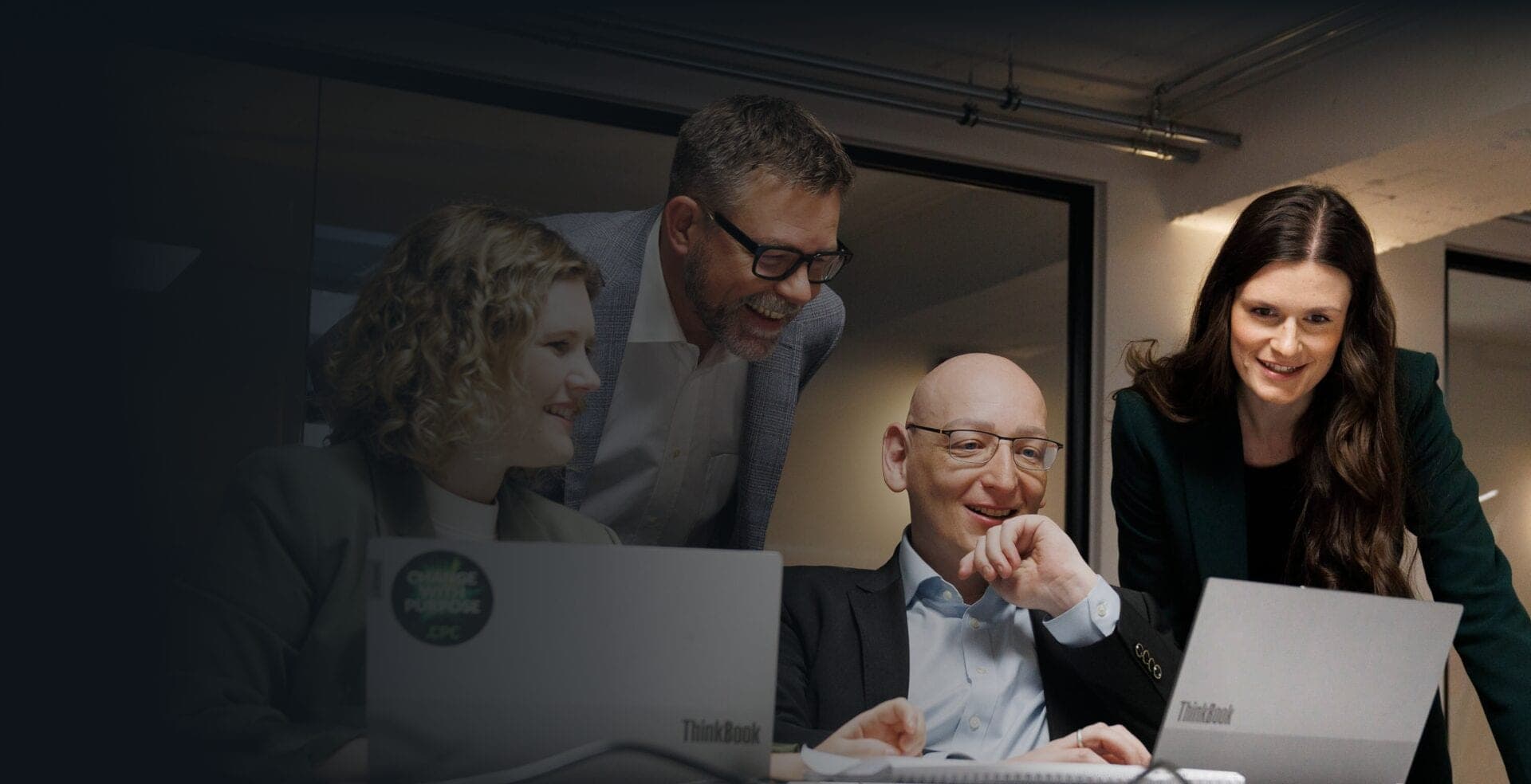 Four CPC consultants in discussion over their laptops