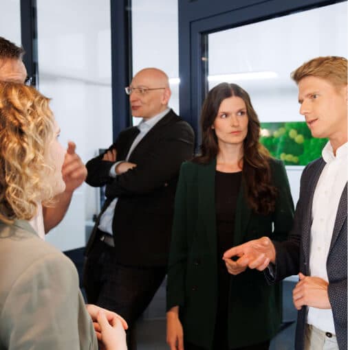 Small group in a standing discussion in an office