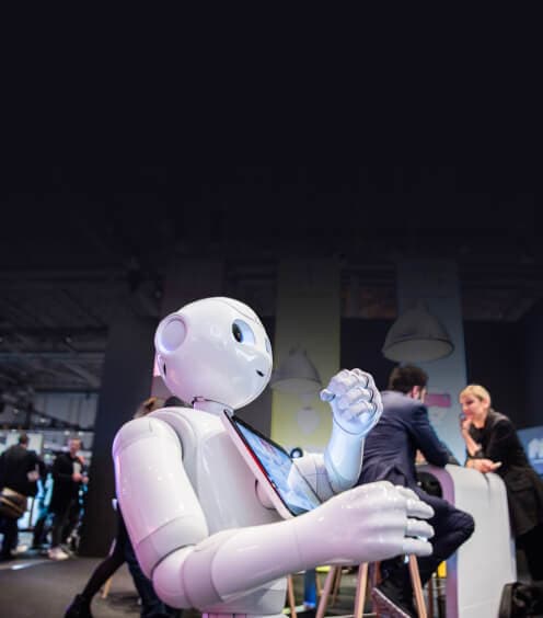 Humanoid service robot holding a tablet at an event