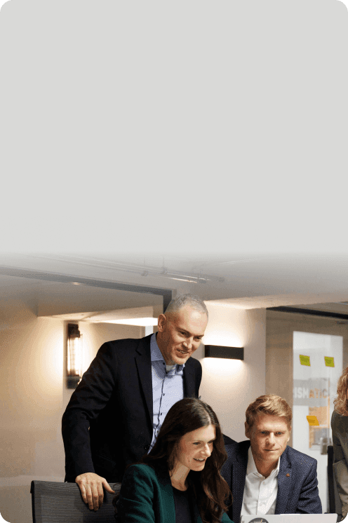 Consulting team talking together over a laptop in the office