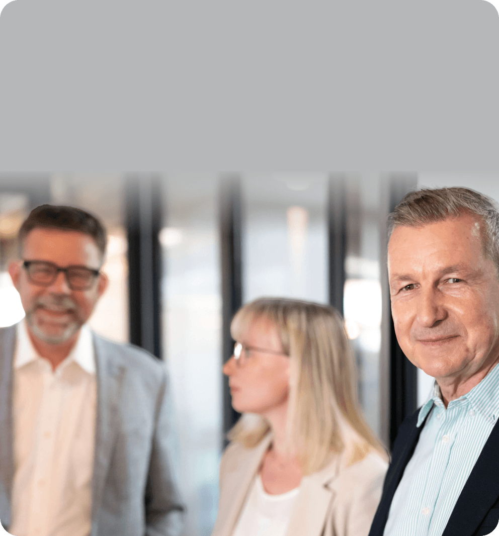 Three colleagues in a bright office