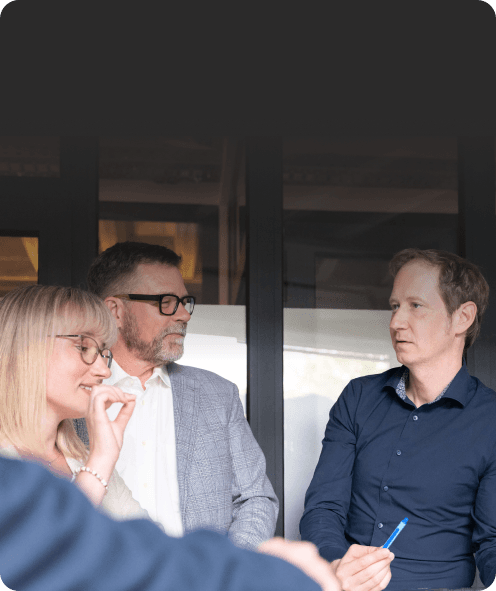 Three people talking in a meeting room