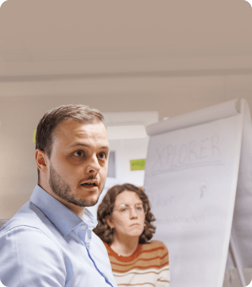 Two workshop participants in front of a flip chart
