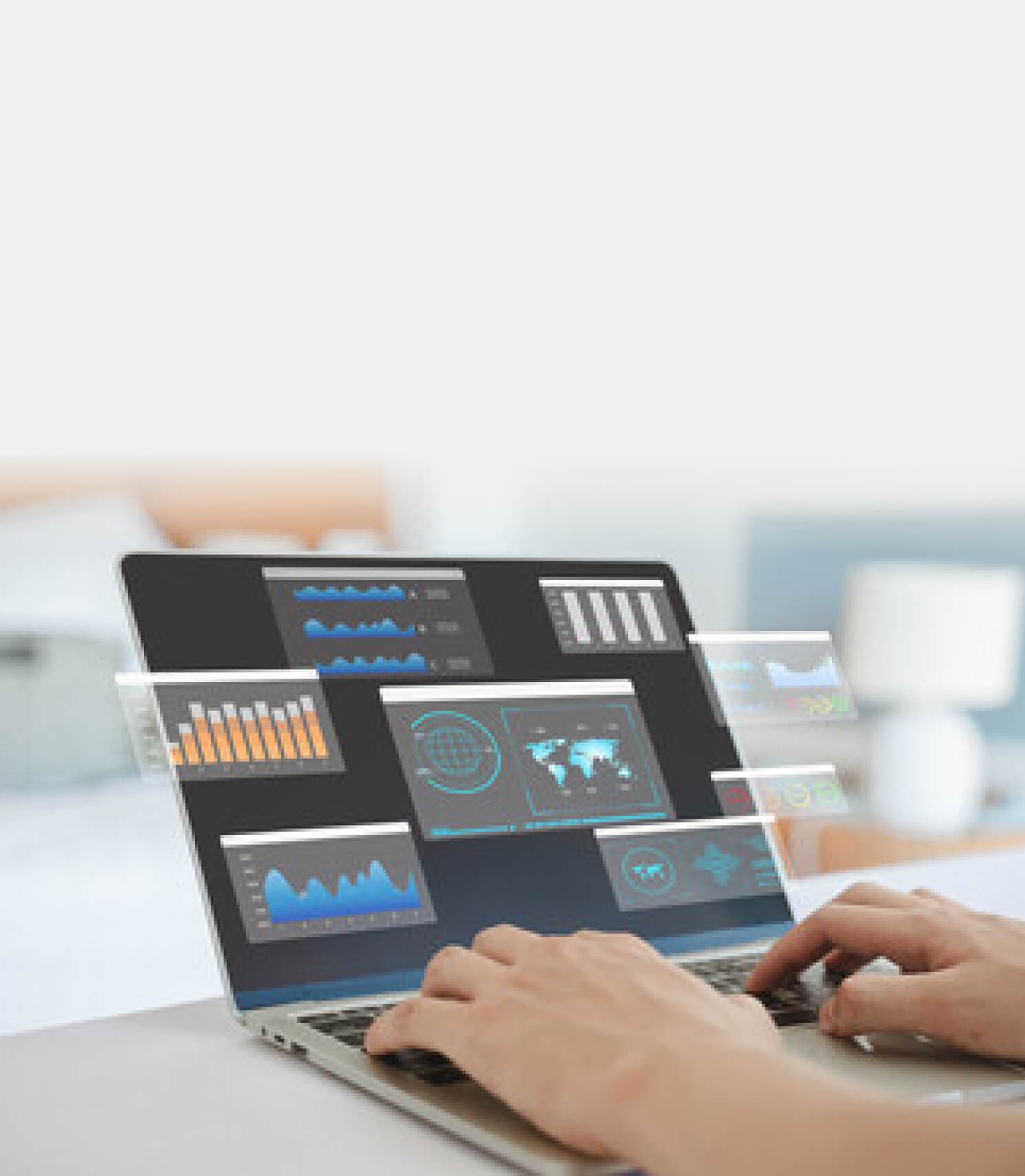 Hands on a laptop showing a sales dashboard